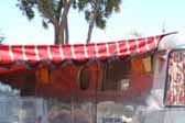 Photo of a 1948 Spartan Manor trailer with a bold red and yellow striped awning