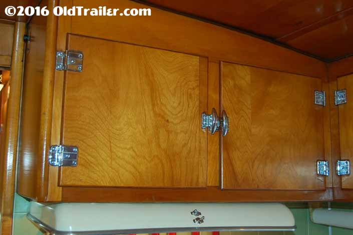This 1951 vagabond trailer has kitchen cabinets with the original hinges and latches