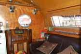 Period furnishings, vintage accessories and a comfy couch in a vintage 1952 Airfloat trailer