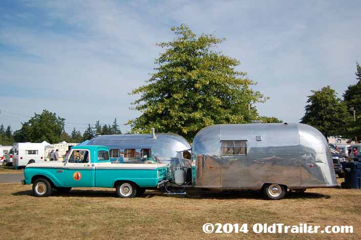 This vintage towing rig is a ford f250 pickup truck pulling a vintage 1958 airstream trailer