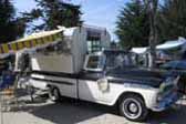 Photo of a restored 1959 chevy apache fleetside pickup truck with a vintage alaskan expanding top camper shell