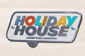 Vintage 1961 Holiday House travel trailer with an original Holiday House cast logo badge on the side