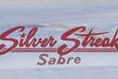Silver Streak Sabre logo script decal in red, from El Monte Calif, on a vintage 1963 Silver Streak Sabre trailer