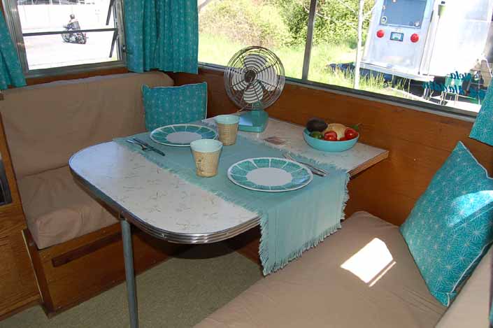 Images shows the beautifully restored dining area in an Aladdin vintage travel trailer