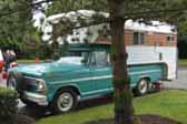 Photo of an original 1968 Ford Pickup truck out camping with a classic Chinook Camper shell mounted in the bed