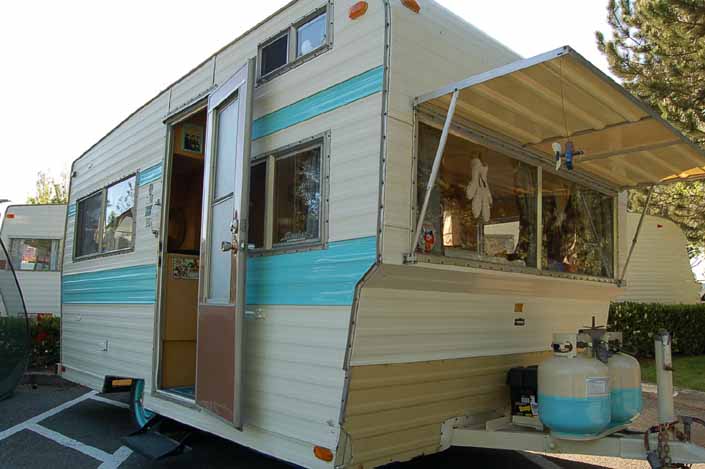 Image shows the front end of a vintage Aladdin Trailer painted light blue and white