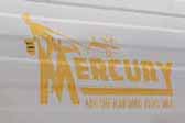Mercury vintage travel trailer with a yellow Merdcury logo graphics decal on the front