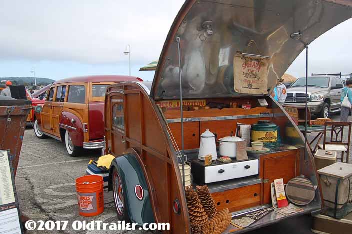 This vintage towing rig is a classic plymouth woodie station wagon pulling a Woodie teardrop trailer