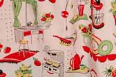 This photo shows a swatch of retro fabric with a cheerful kitchen appliances illustrations pattern, for your vintage trailer