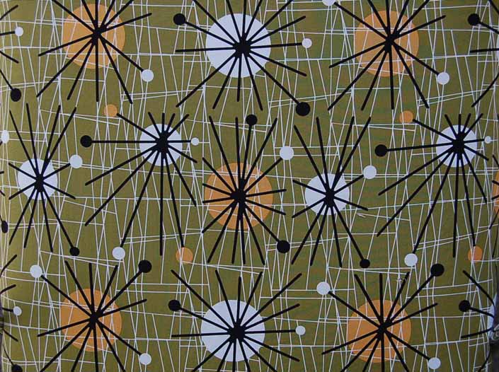 This photo shows a swatch of retro fabric with mid-century starbursts for your vintage trailer