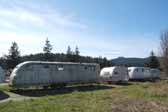 Photo of a group of vintage trailers from the 50's and 60's stored in a vintage Trailer Junk Yard