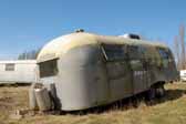A painted older Airstream Trailer stored in a Vintage Trailer Junk Yard