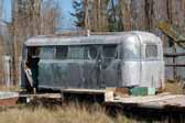 Photo of a rare Palace trailer stored in a vintage trailer junkyard and ready to be restored