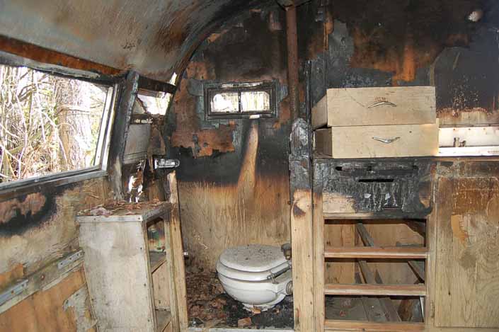 Shasta 16SC trailer in a vintage trailer Storage Yard has severe fire damage to the bathroom area