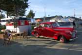 Photo shows 1937 hayes vintage trailer and vintage chevy coupe tow vehicle