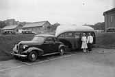 Photo of a vintage coupe towing a US public service trailer in 1937