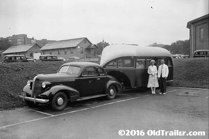 This vintage towing rig is a vintage coupe pulling a US Public Service Trailer in 1937