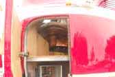 This is a close-up shot of the open access door and mecvhanicals closet in a 1941 GM Futurliner bus