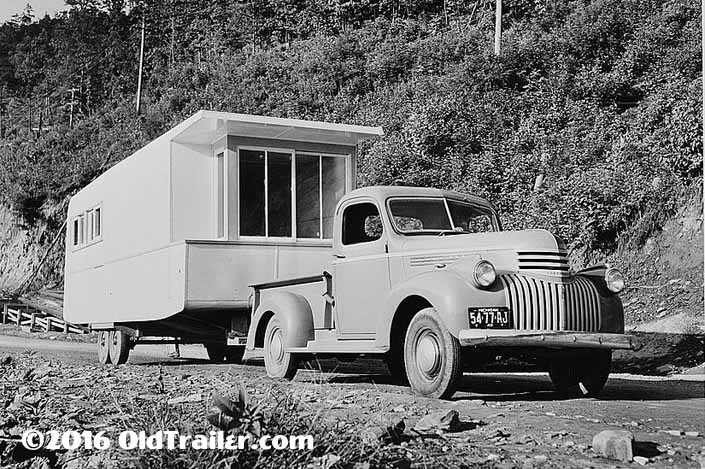 This vintage towing rig is a vintage chevy pickup truck pulling a 1941 manufactured trailer