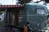 Photo of a beautiful vintage 1948 Vagabond trailer with a striped side awning