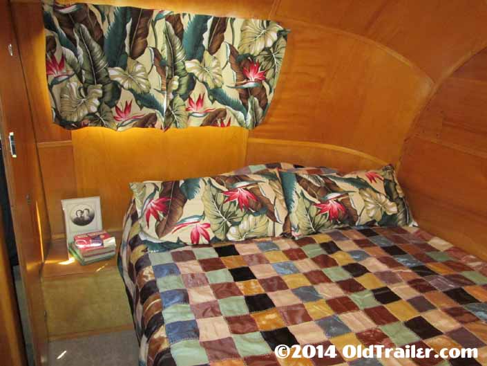 Vintage 1948 Vagabond travel trailer rear bedroom has beautiful birch ceiling paneling