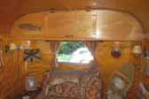 Photo of Adirondack hunting lodge accessories in vintage 1948 Westwood Coronado travel trailer living room