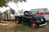 Photo shows a vintage studebaker pickup towing a 1949 curtis wright vintage trailer