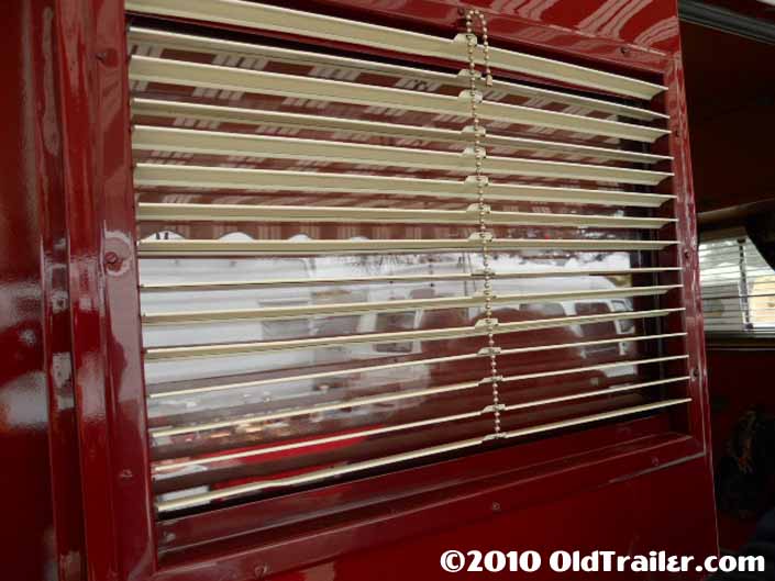 Front door in this 1949 Vagabond trailer still has the original metal venetion blinds