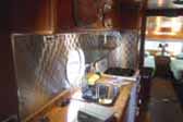 1950 Airfloat Land-Yacht travel trailer with a great retro quilted stainless steel backsplash in kitchen