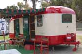Photo of a restored 1950 vintage Vagabond trailer with dark green side awning