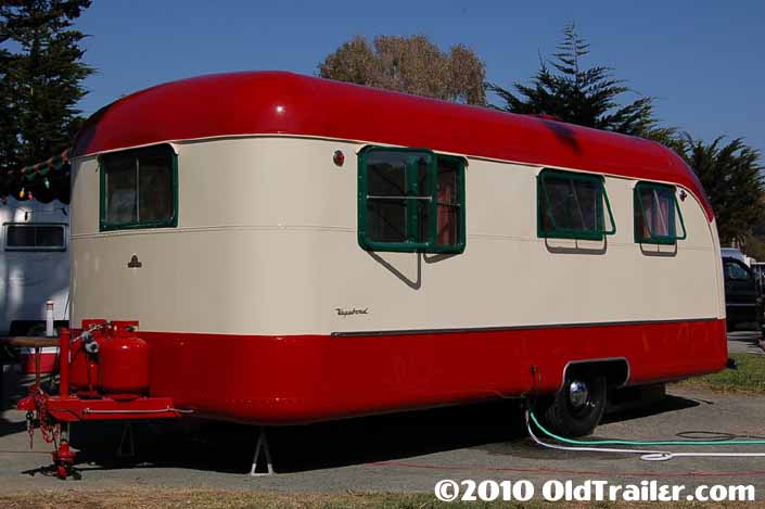 This 1950 Vagabond trailer is painted red and creme with dark green window frames
