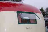 Photo shows the original hinge-up bedroom window in a restored 1950 Vagabond trailer