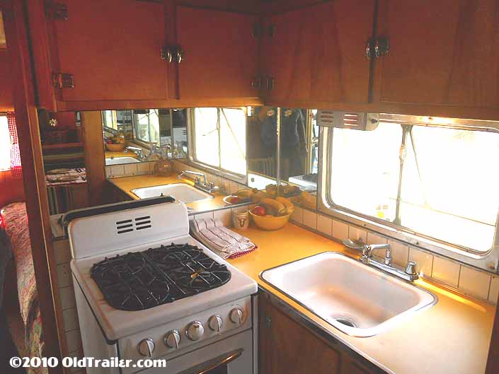 This 1950 vagabond trailer has bright yellow plastic laminate on the kitchen counter
