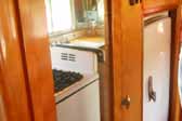 Photo shows the fridge and gas stove in a vintage 1950 Vagabond travel trailer