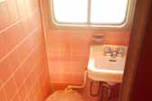 Photo of the original pink bathroom tile in a restored 1951 Vagabond trailer