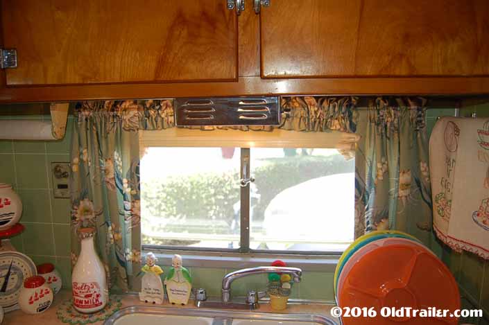 Photo shows restored 1951 Vagabond trailer side window over the kitchen sink