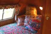 Photo of the cozy back bedroom in a restored 1951 Vagabond vintage trailer