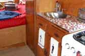 1952 Airfloat trailer has new kitchen sink and faucets and small square mosiac tiled countertop