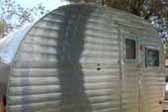 Beautifully polished aluminum siding on a classic 1953 Aljoa Travel Trailer