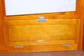 Beautifully restored cabinet door below the fridge in a vintage 1953 Aljoa Trailer