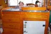 Perfectly restored birch kitchen cabinet in a 1953 Aljoa trailer
