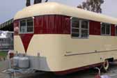Photo shows the front end view of a 1953 Vagabond vintage trailer