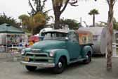 Photo of a 1954 chevy pickup truck towing a vintage trailer