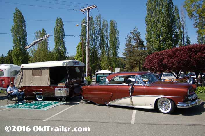 This vintage towing rig is a vintage mercury coupe pulling a vintage 1954 sport ranger pop-up trailer
