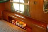 Photo shows 1955 Aljoa Sportsman trailer with awesome wood rounded headboard in bedroom area
