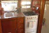 Interior shot shows kitchen in 1955 Aljoa Sportsman Trailer, with a vintage Dixie stove & oven unit