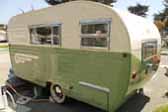 Photo of side view of restored vintage 1955 Aljoa Sportsman Trailer