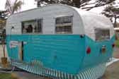 1955 Aljoa Canned Ham Trailer painted in turquoise and white 2-tone paint scheme