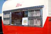 Restored and polished original front window frame on a classic 1955 Aljoa travel trailer
