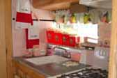 Beautifully decorated kitchen in 1955 vintage Aljoa trailer